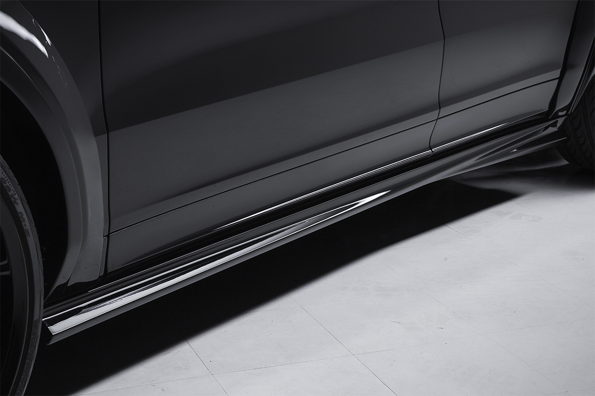 WALD Porsche Cayenne Coupe side skirt detail — WALD Black Bison side skirt along the sill of a black Cayenne Coupe