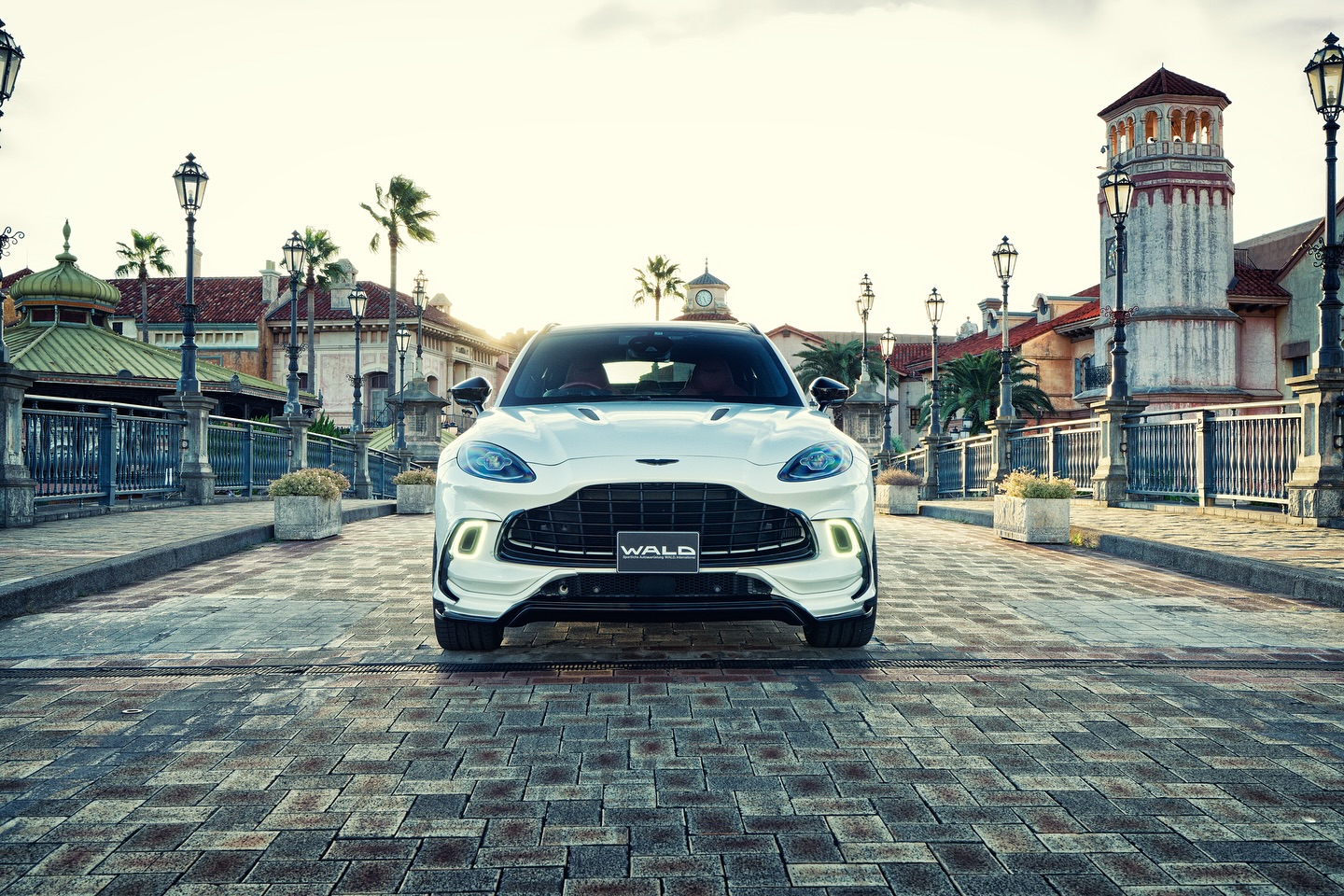 WALD Aston Martin DBX — head-on front view of a white DBX showing the WALD front lip spoiler, grille and bonnet vents