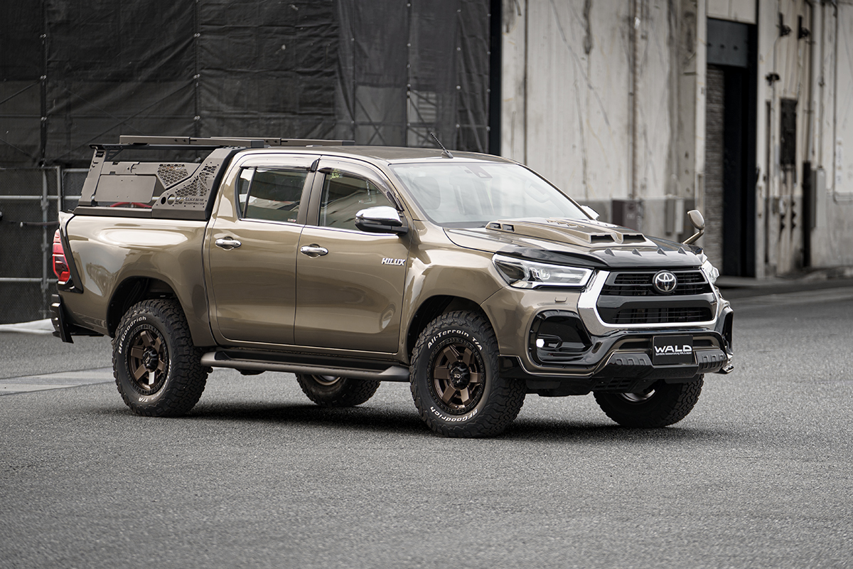 WALD Toyota Hilux GUN125 facelift in bronze with wide arch package, side steps and bed rack
