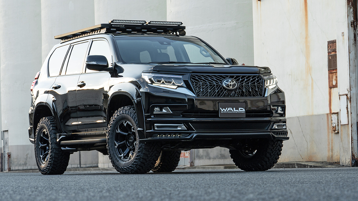 WALD Black Bison Edition Prado 150 front three-quarter view with WALD front grille, front spoiler LED lamps and wide arch package
