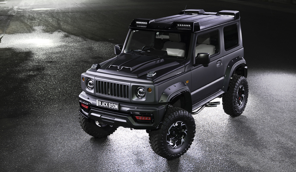 WALD Black Bison Edition Suzuki Jimny JB74W — elevated front three-quarter view showing the aero bonnet, wide arch package and Black Bison plate