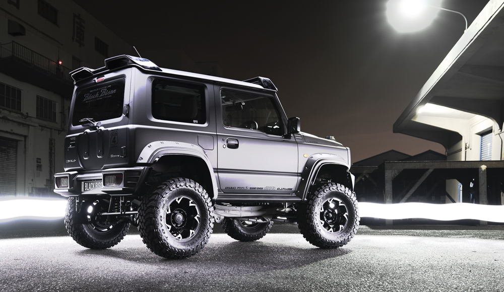 WALD Black Bison Edition Suzuki Jimny JB74W — rear three-quarter view showing rear wing, spare tyre cover and wide arch package