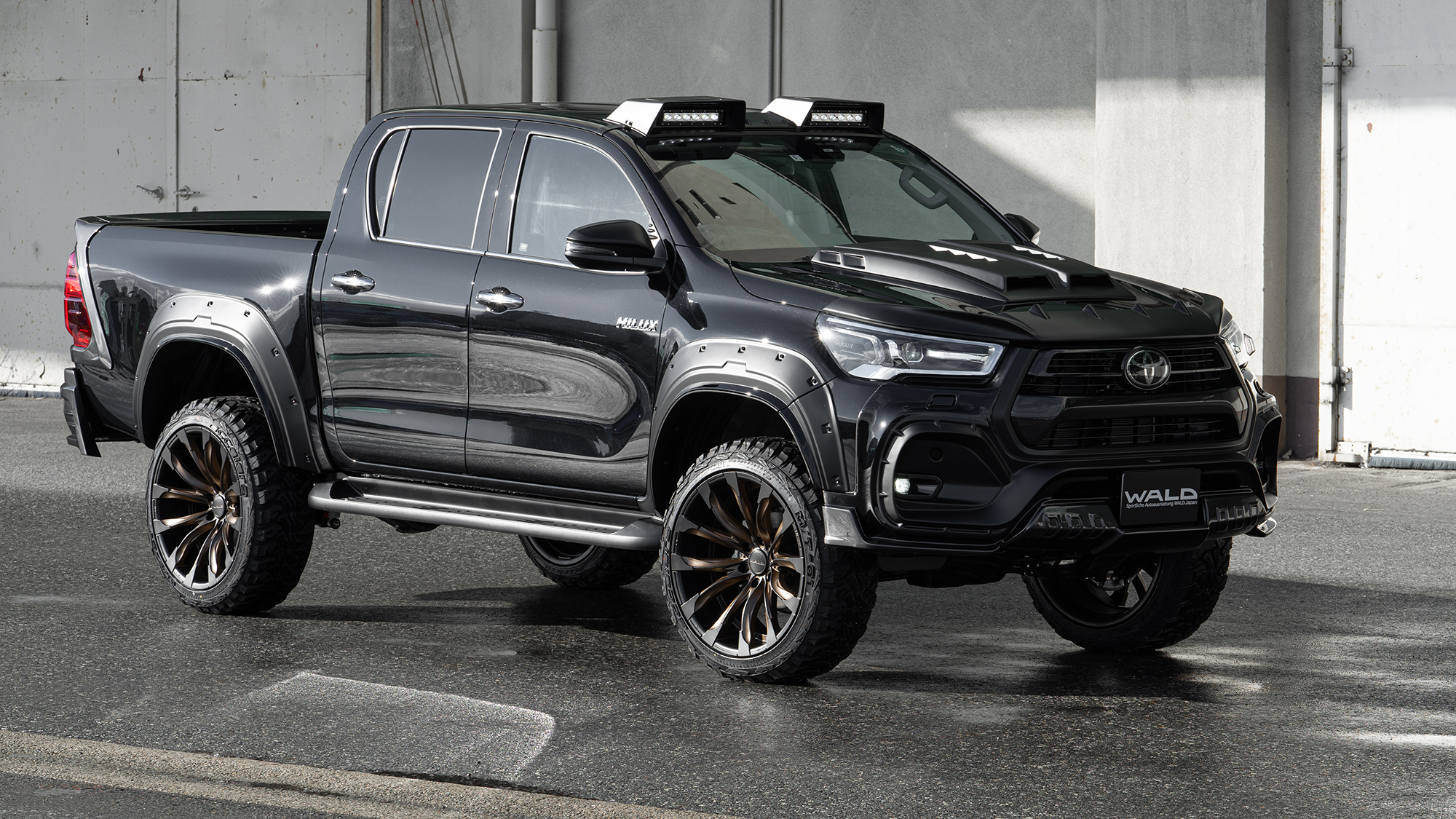 Toyota Hilux WALD wide-body conversion on JARRET J11C wheels, front three-quarter view