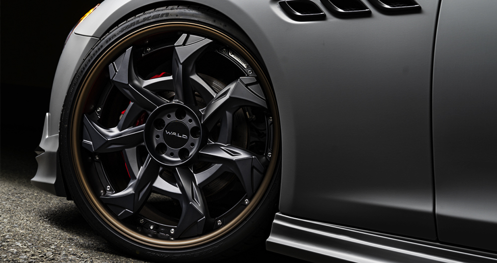 Close-up of WALD forged wheel and front fender on the matte grey Maserati Quattroporte