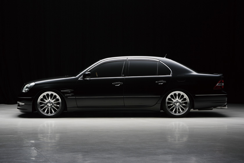 WALD Executive Line Toyota Celsior UCF30/31 M/C before — full side profile on a black studio background with complete WALD Executive Line body kit