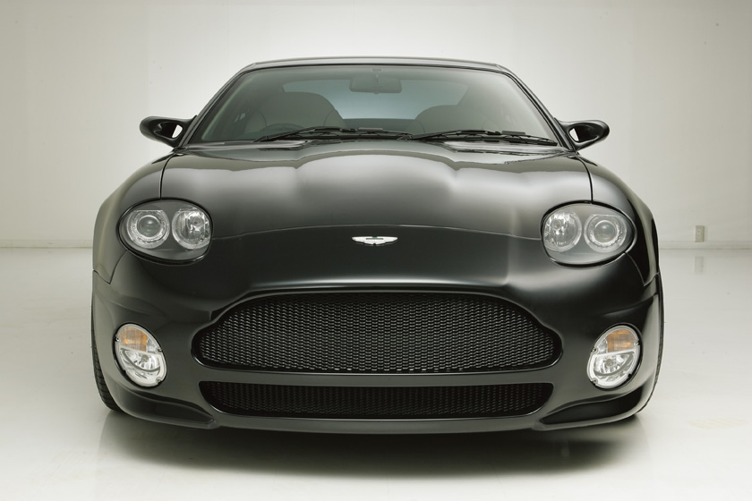 WALD Aston Martin DB7 body kit UK — head-on front view of black DB7 with WALD Sports Line front bumper spoiler and mesh grille