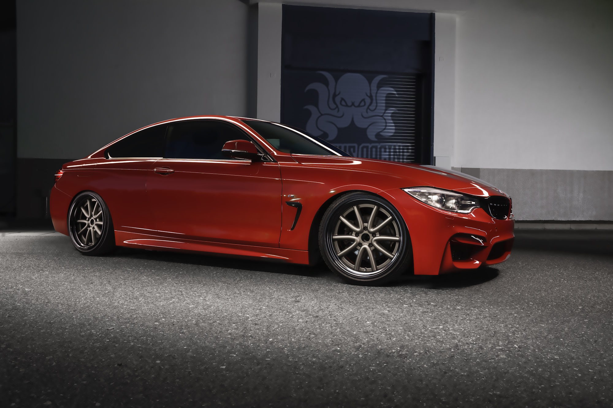 Red BMW 4 Series coupe fitted with WALD Octopus Racing wheels