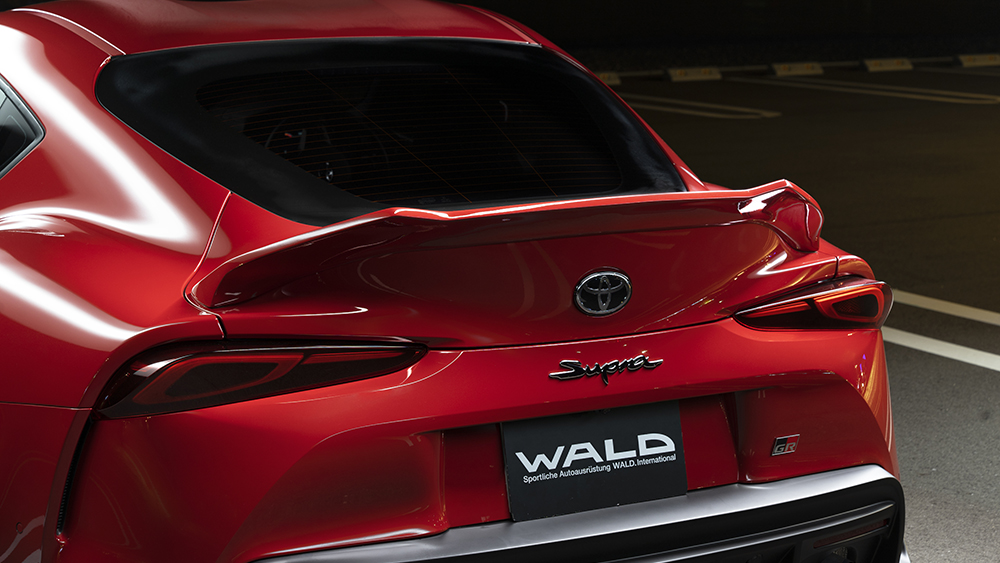 WALD rear wing and boot spoiler detail on the red Toyota GR Supra DB##