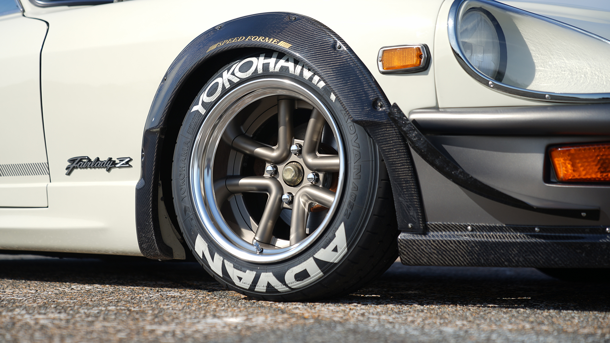 Close-up of a WALD Octopus Racing wheel on a white Fairlady Z S30
