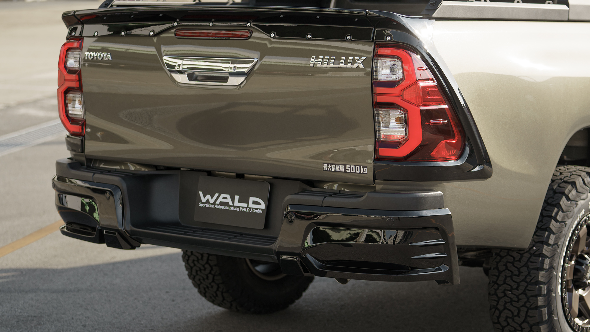 Close-up of the WALD Black Bison tailgate spoiler and rear bumper styling on the Toyota Hilux GUN125