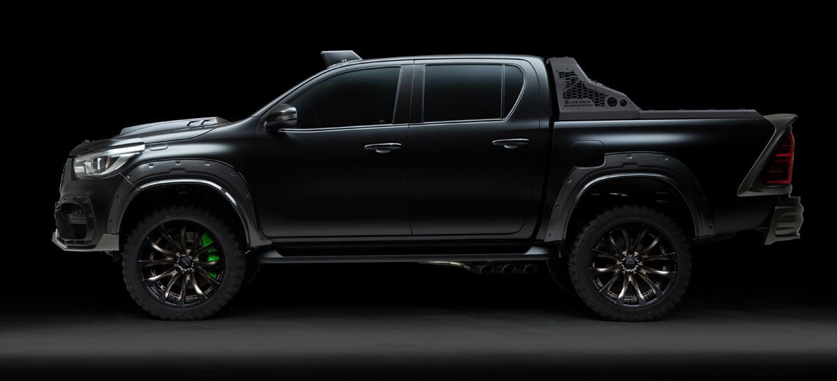 WALD Black Bison Toyota Hilux GUN125 side profile showing wide arches, side steps and roll bar