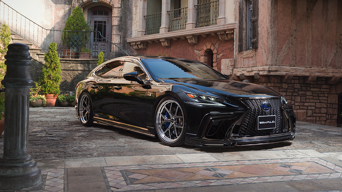 WALD Lexus LS500 F SPORT front three-quarter view on cobbled European street with WALD front spoiler