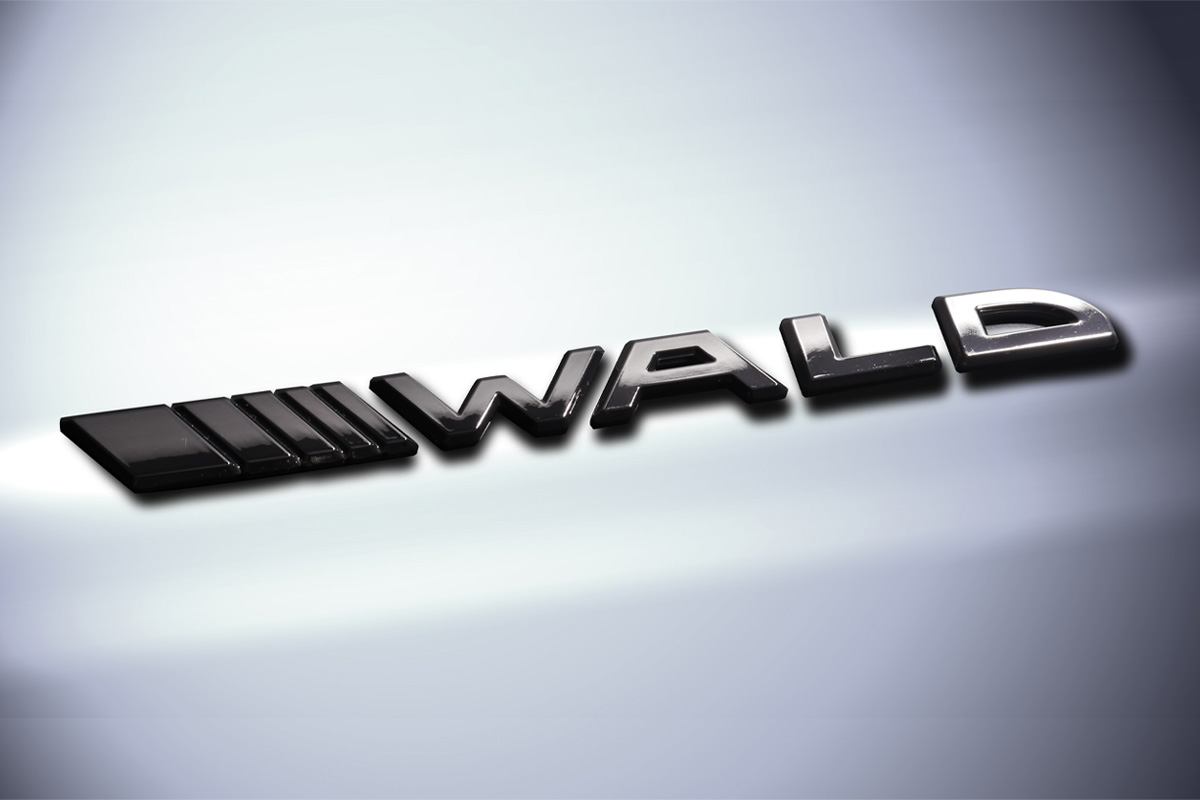 WALD Separate Slash Emblem in black clear finish on a white vehicle body panel
