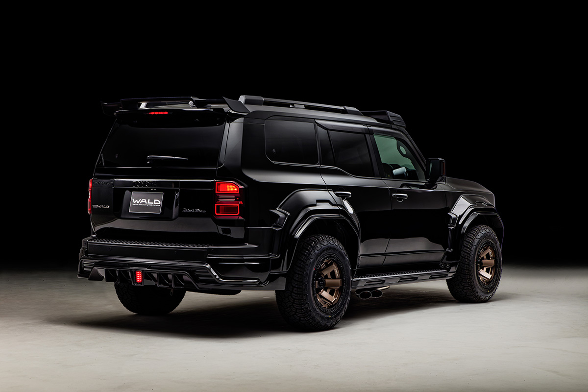 WALD Black Bison Land Cruiser 250 Prado rear three-quarter studio view with wide arches and 17-inch bronze WALD wheels