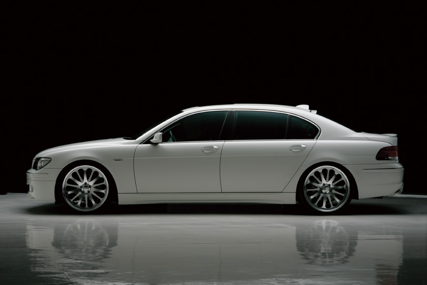 WALD BMW E65 E66 body kit full side profile showing WALD side skirts and lowered stance on white 7 Series