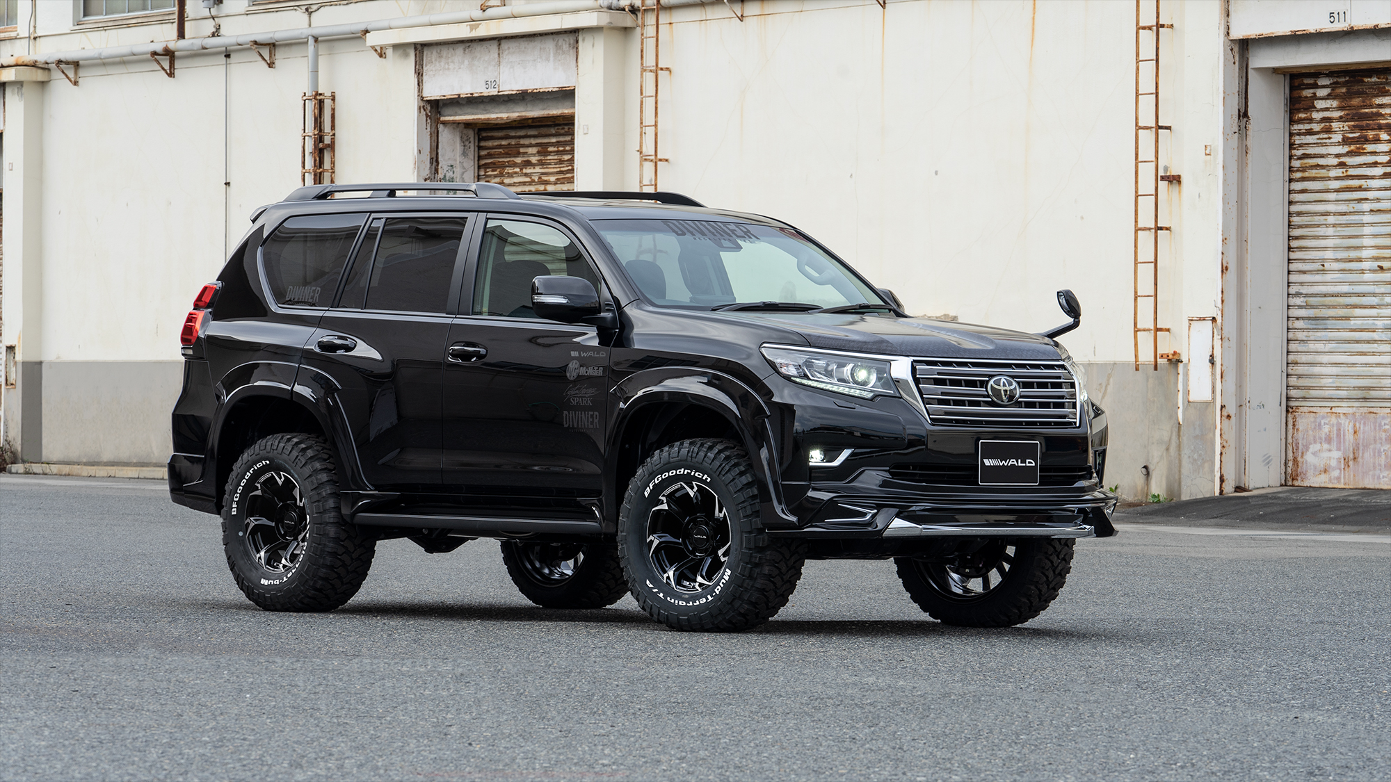 Black WALD Sports Line Prado 150 front three-quarter view on off-road tyres and black wheels