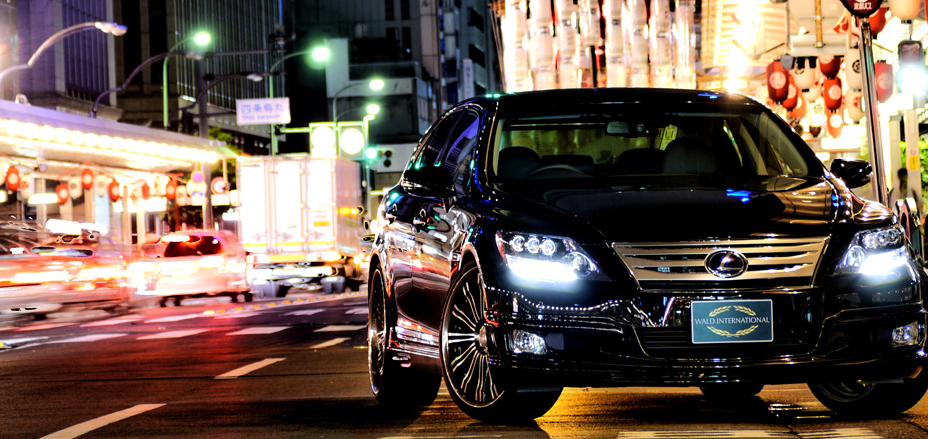 WALD Executive Line Lexus LS600h on a Japanese city street at night with lights streaking past