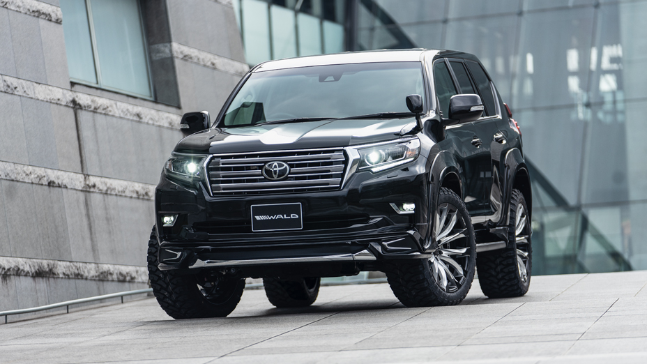 Black WALD Sports Line Prado 150 front three-quarter view with front spoiler and WALD wheels