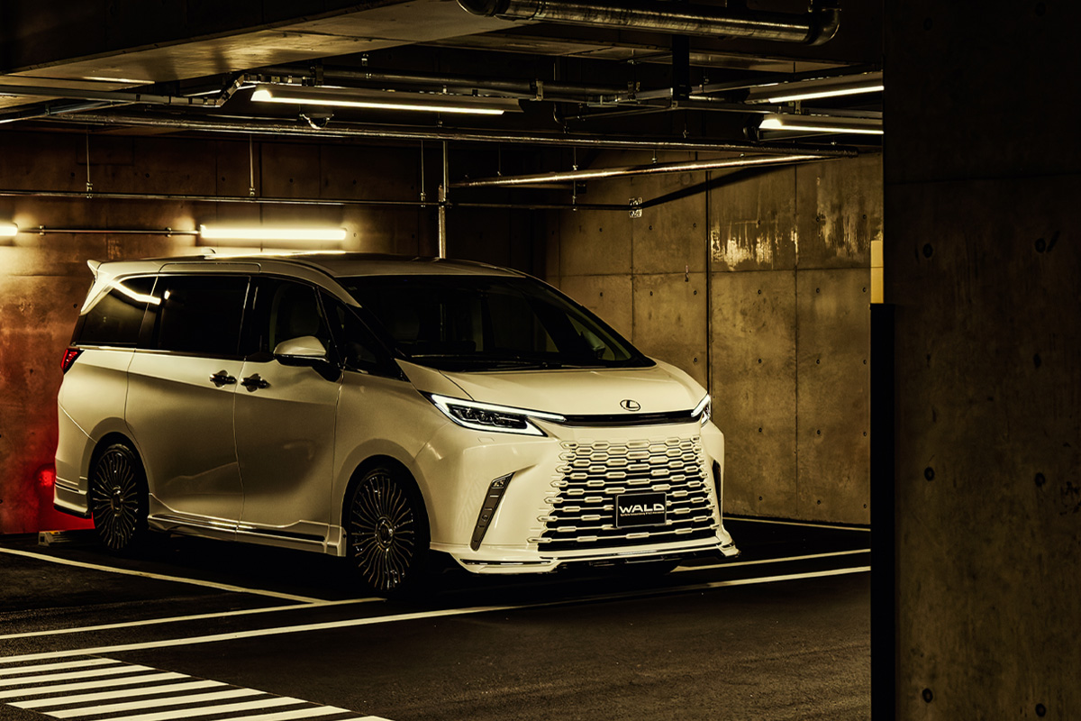 White Lexus LM500h with WALD Sports Line styling fitted with WALD RENOVATIO II R21C wheels in an underground car park
