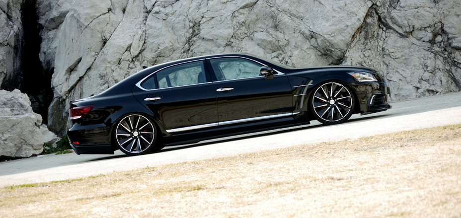 WALD Executive Line Lexus LS460L low side profile beside rocks showing WALD side skirts and sports fender ducts