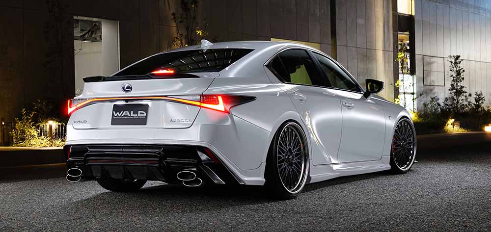 WALD Sports Line Lexus IS300h rear three-quarter at night with WALD rear skirt, boot spoiler and stainless steel exhaust tips
