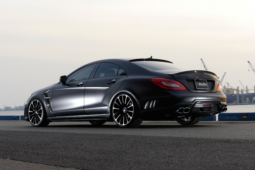 WALD Black Bison Mercedes-Benz CLS C218 rear three-quarter view by the harbour with boot spoiler and quad exhaust tips