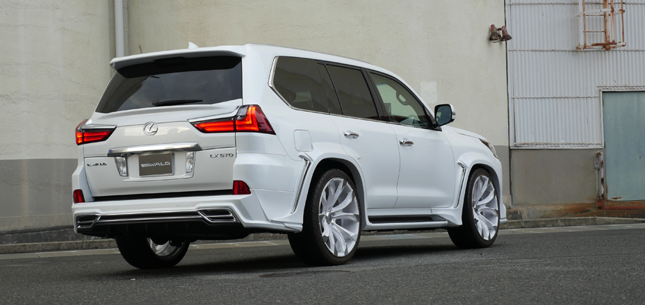 White WALD Lexus LX570 rear three-quarter view with rear skirt, tailgate spoiler and wide arch package