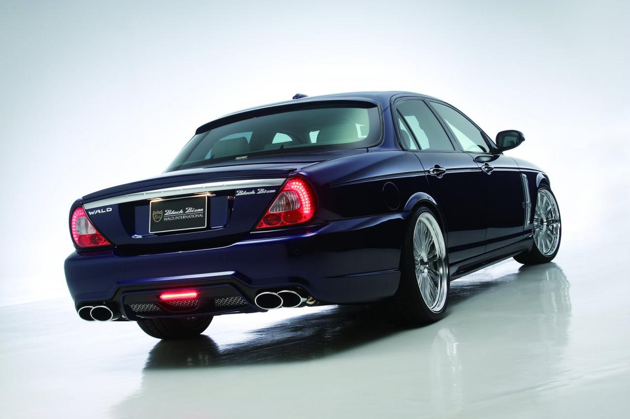 WALD Black Bison Jaguar XJ X358 studio rear three-quarter view with Black Bison badging and quad oval exhaust tips
