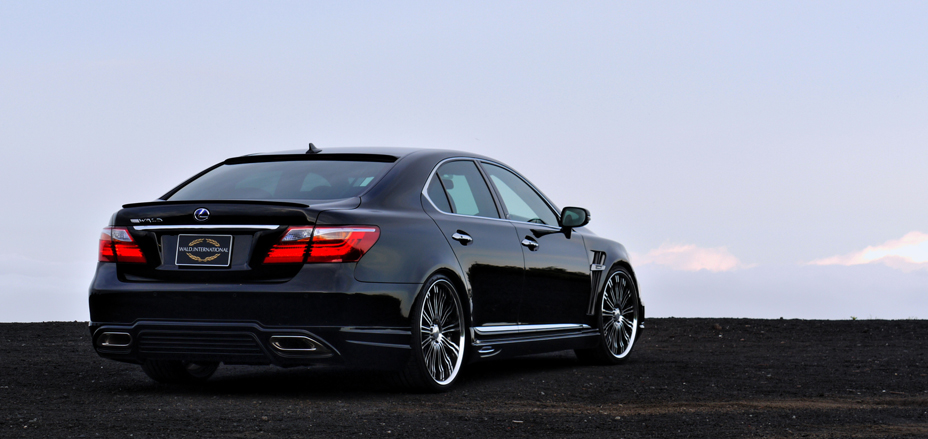 WALD Executive Line Lexus LS600h rear three-quarter view with WALD rear skirt and boot spoiler at dusk