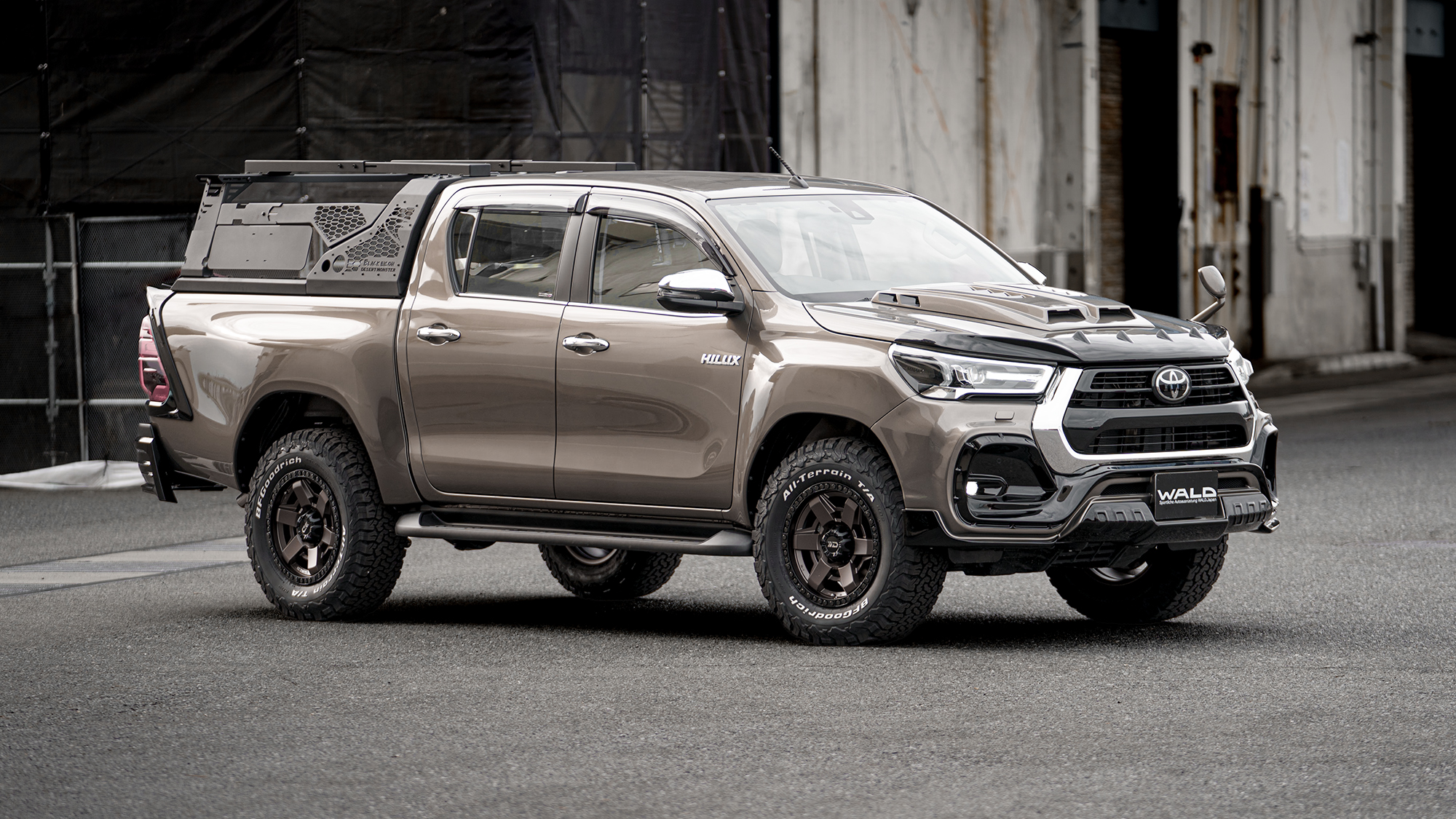 Bronze Toyota Hilux with WALD bonnet and arch kit on Desert Line DS001 Matte Bronze Black wheels