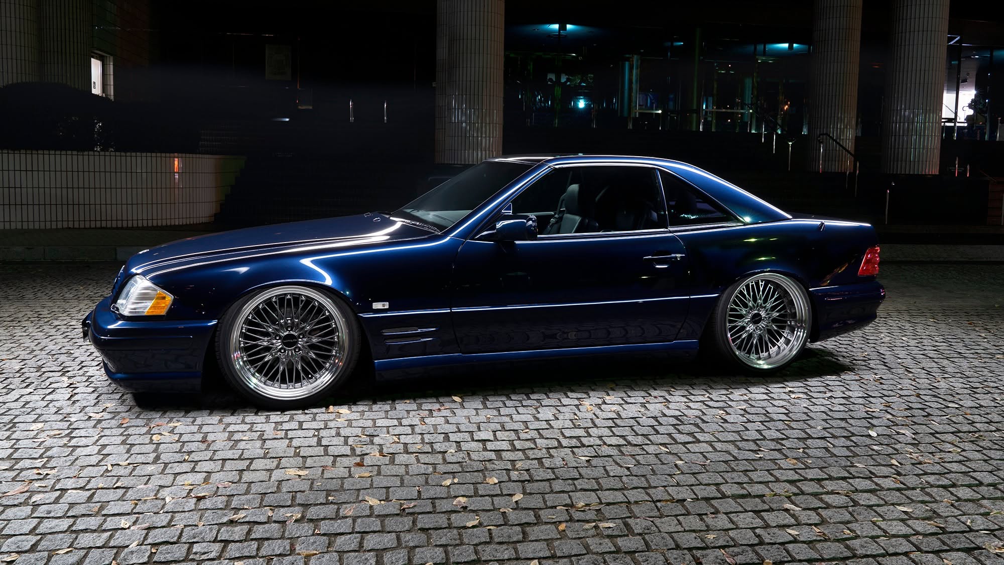 WALD Mercedes-Benz SL-Class R129 with hardtop — dark blue SL full side profile at night on multi-spoke WALD wheels
