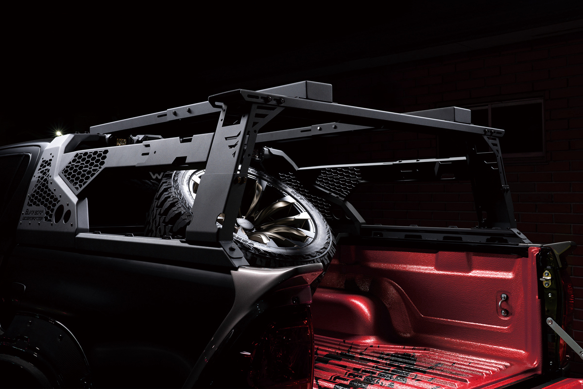 Night view of the WALD Black Bison Desert Monster roll bar, bed rack and spare tyre hanger on the Toyota Hilux GUN125