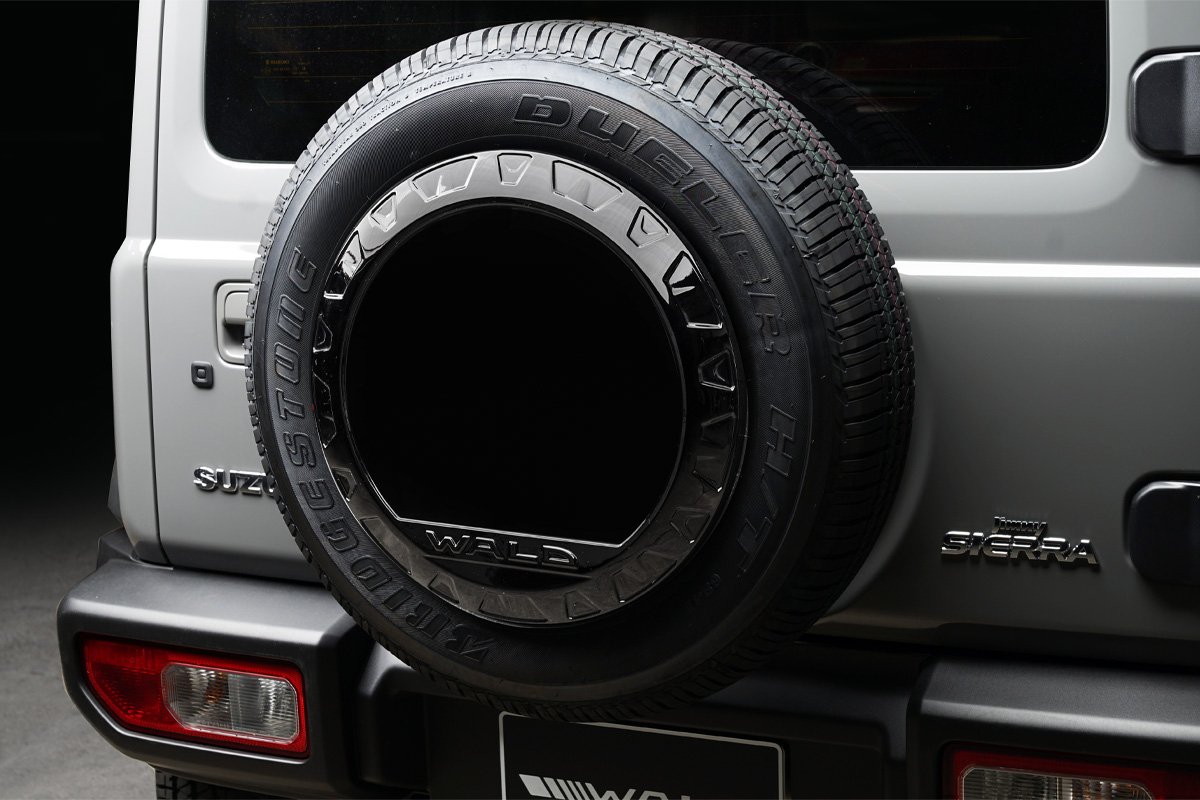 WALD Black Bison Edition Suzuki Jimny Sierra JB74W — rear view detail of the spare tyre cover with WALD lettering on a silver Jimny Sierra