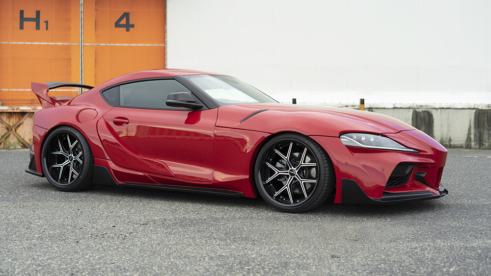 Red WALD wide body Toyota Supra side profile with rear over fenders, boot spoiler and rear wing