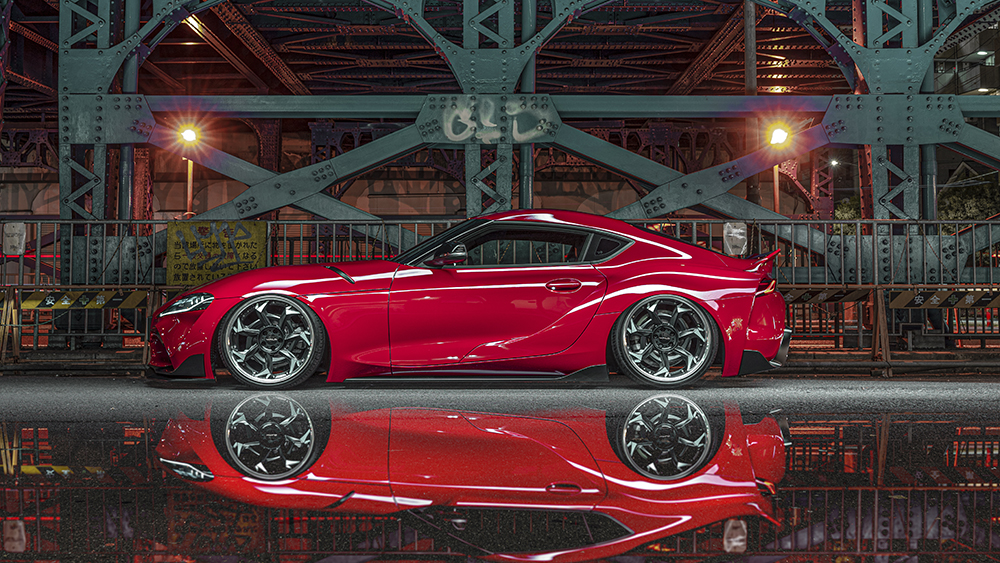 Side profile of the red WALD Sports Line Toyota Supra DB## with side skirts and WALD wheels