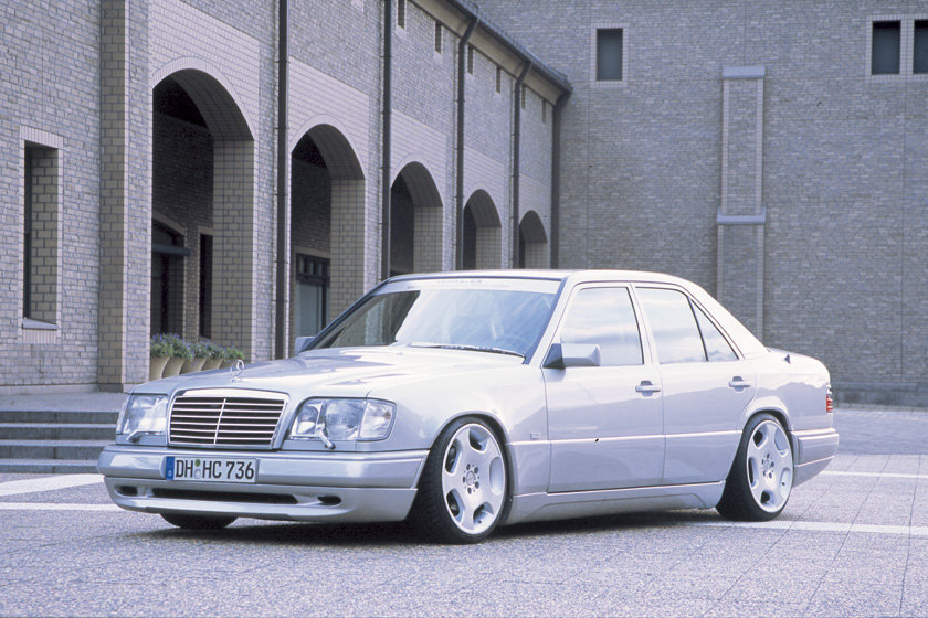 Silver Mercedes-Benz E-Class W124 WALD Executive Line front three-quarter view with WALD front spoiler and forged wheels