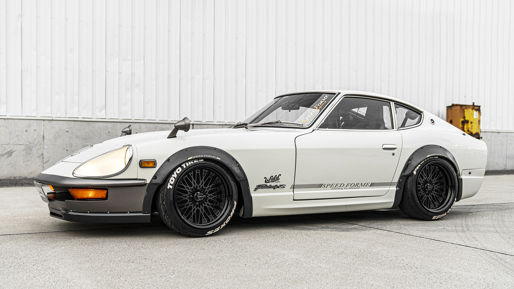 White Nissan Fairlady Z widebody on matte black WALD Classic Mesh CM12C wheels