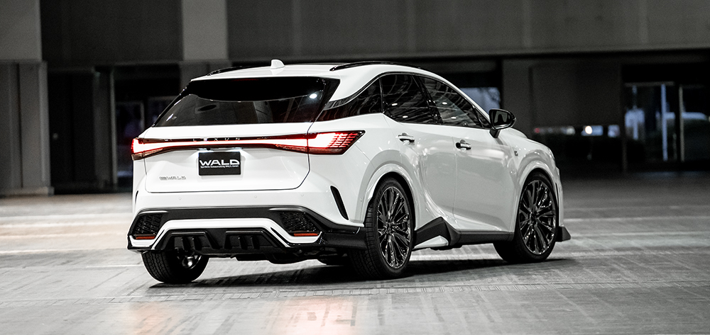 WALD Lexus RX rear three-quarter — white Lexus RX500h F SPORT with WALD rear skirt diffuser and WALD number plate