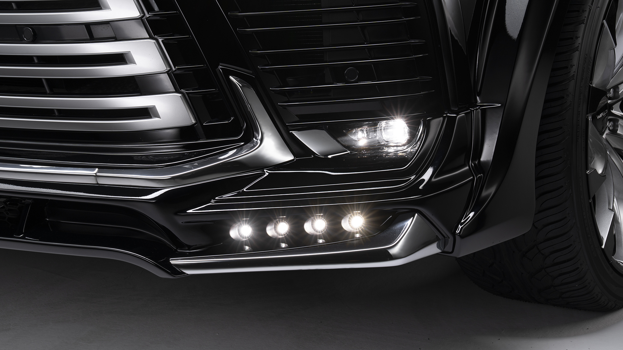 WALD Lexus LX600 front spoiler LED lamp detail — LEDSL10P four-lamp LED unit illuminated
