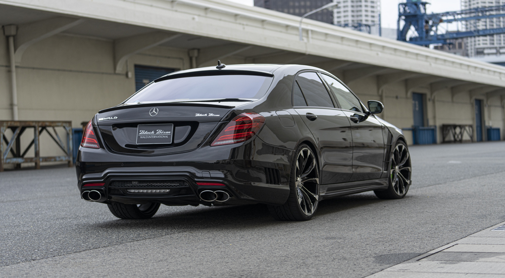 Rear three-quarter view of black WALD Mercedes-Benz S-Class W222 with rear bumper spoiler and quad exhaust tips