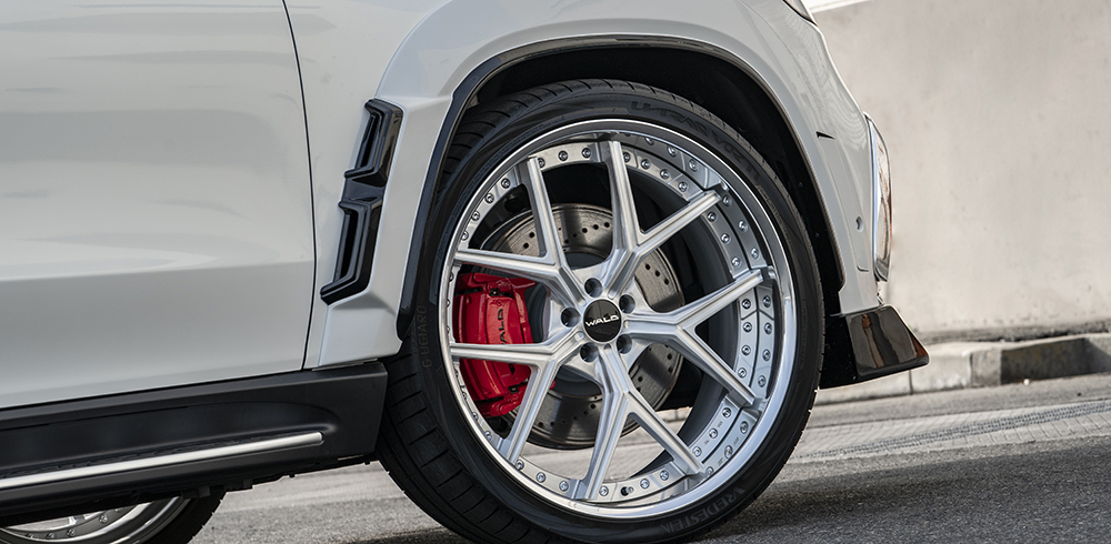 WALD Black Bison GLS X167 front wheel and wide arch detail with WALD multi-piece wheel