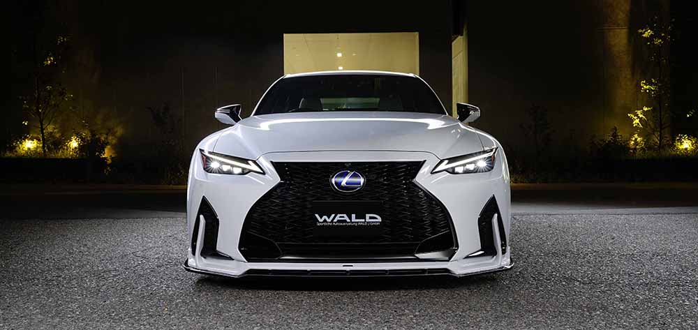WALD Sports Line Lexus IS head-on front night view showing the front spoiler vertical fins