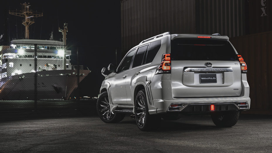 Silver WALD Sports Line Prado 150 rear three-quarter view at the dockside at night