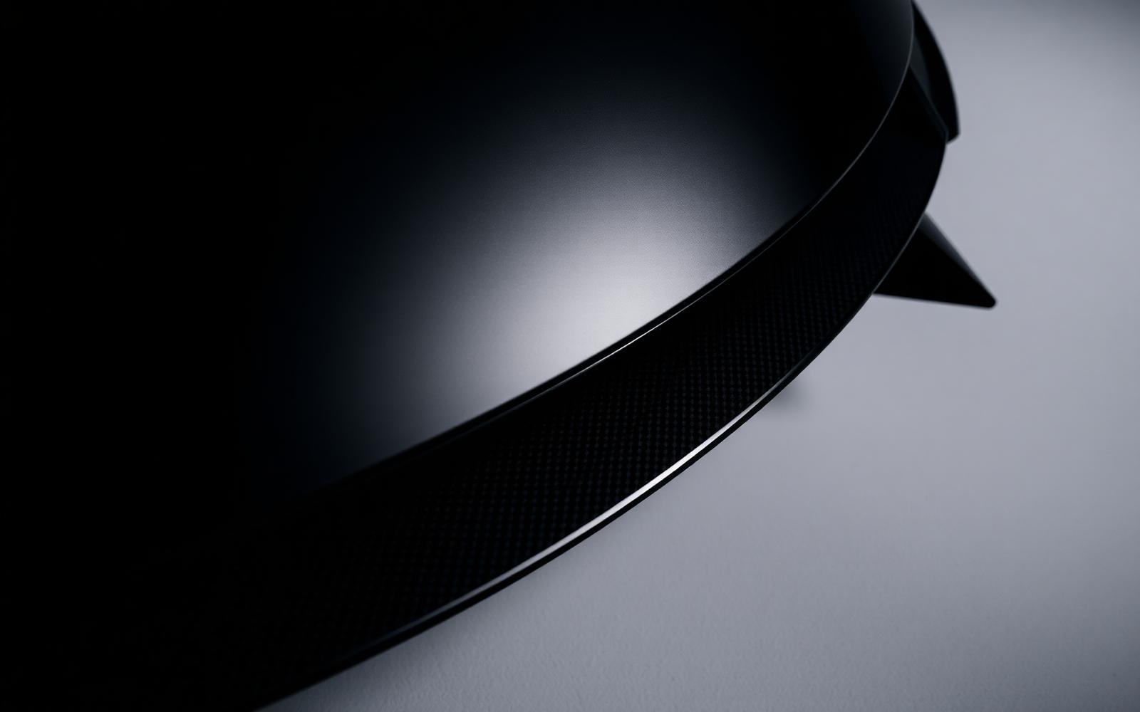 Carbon fibre detail on a WALD-style rear spoiler under studio lighting